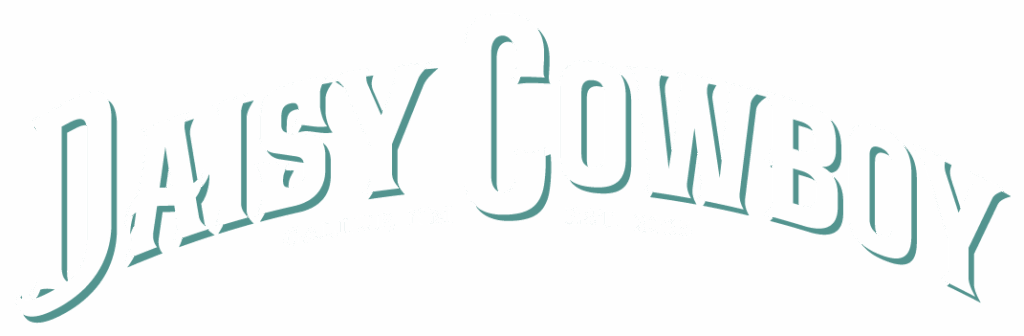 White, bold, arched text reads Daisy Cowboy with smaller text underneath: Gallup, NM Est. 2025. Text has a teal drop shadow on a transparent background.