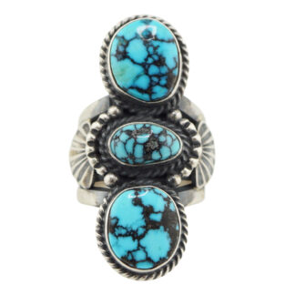 The “Twin Spirits” Revival Ring by Derrick Gordon (Navajo) features three vertically set oval turquoise stones with black veining, surrounded by intricate silverwork for a striking and elegant look.