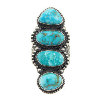 The “Twin Spirits” Revival Ring by Derrick Gordon (Navajo) is a silver ring with four vertically set turquoise stones in oval and teardrop shapes, accented by rope and dotted metal details around each stone.