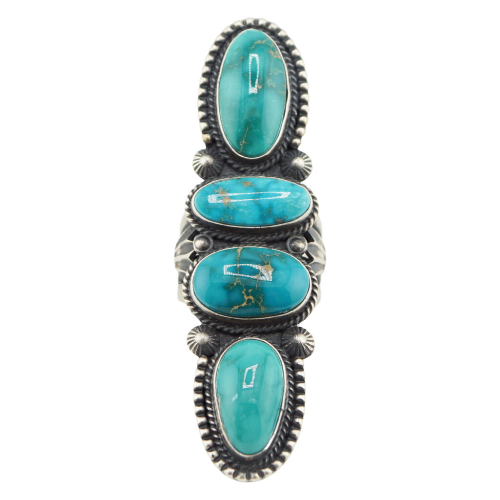The “Twin Spirits” Revival Ring by Derrick Gordon (Navajo) showcases four vertically set oval turquoise stones in detailed silver bezels with rope borders.