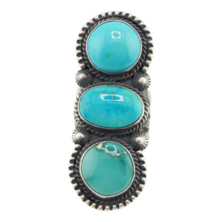 The “Twin Spirits” Revival Ring by Derrick Gordon (Navajo) showcases three vertically set oval turquoise stones in detailed silver bezels with rope-style edges and delicate silver accents between the stones.