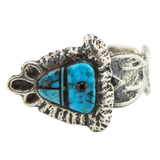 A silver ring featuring a stylized fish design, with an inlaid turquoise stone accented by black lines and natural veining, set in a textured, oxidized metal band.