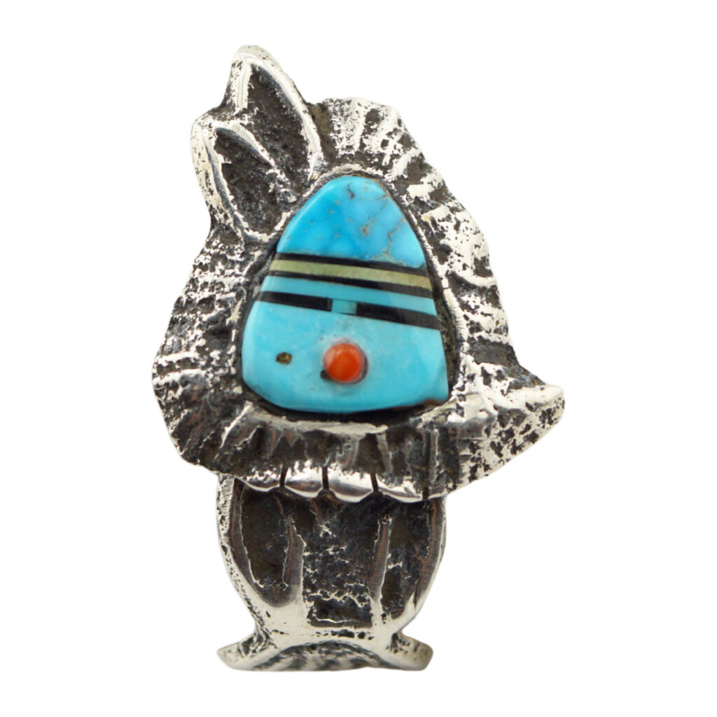 A silver ring shaped like a stylized rabbit, featuring inlaid turquoise, black stripes, and a small red dot as decorative accents on its head.