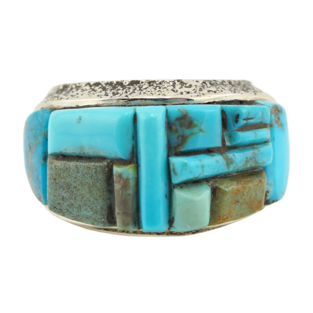 A silver ring featuring a mosaic inlay of various rectangular turquoise stones in different shades of blue and green.