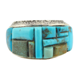 A silver ring featuring a mosaic inlay of various rectangular turquoise stones in different shades of blue and green.
