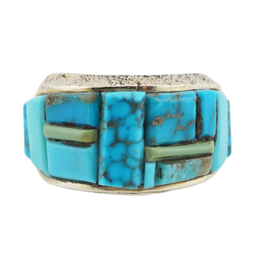 A silver ring featuring an inlay design with rectangular and square turquoise stones, some with brown matrix patterns and a few thin greenish stone accents.