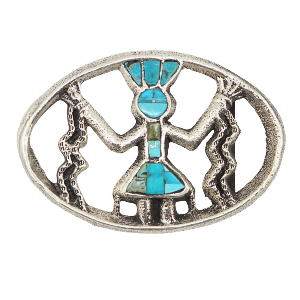 Oval silver belt buckle featuring an inlaid turquoise figure with outstretched arms, standing between two zigzag lines, possibly representing lightning or energy. The design appears inspired by Native American art.