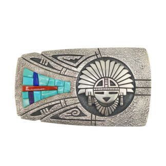 A silver belt buckle featuring an engraved Native American sun face design and colorful inlaid turquoise, blue, red, and purple geometric patterns on the left side.