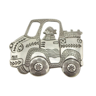 A decorative metal ornament shaped like a stylized car with geometric patterns, featuring a person wearing a headscarf sitting inside. The design has intricate, embossed details and a whimsical appearance.